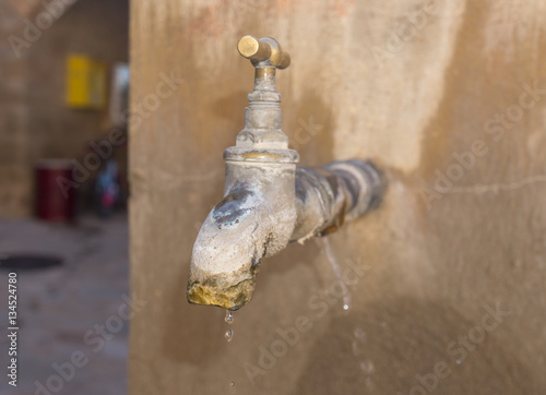 old faucet with lime deposit calcified. Faucet with water leak detali photo