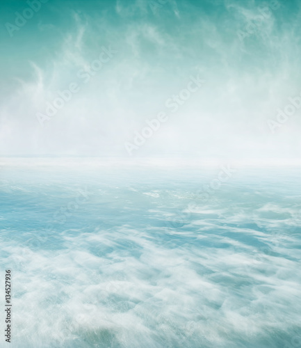 Swirling Sea and Fog. A long exposure of fog swirling above turbulent ocean water. Fog area provides plenty of copy space.