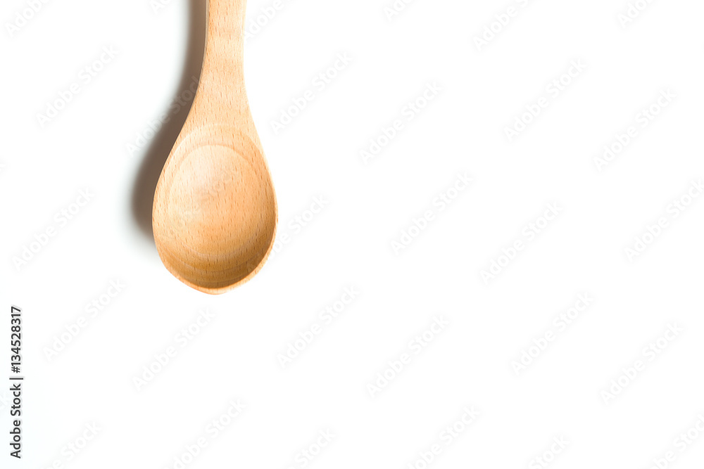 A wooden spoon isolated over white background A wooden spoon isolated over white background