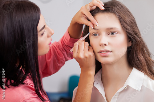 beautiful models In the beauty salon, make-up artist doing make-up