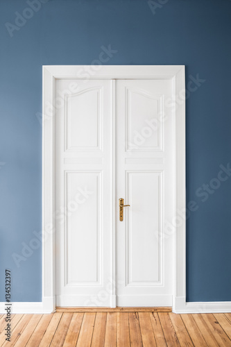 white wooden door, blue wall 