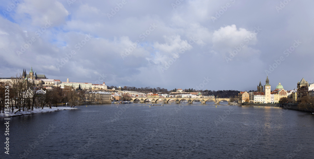 Fototapeta premium Snowy freeze Prague Lesser Town with gothic Castle and Charles Bridge, Czech republic