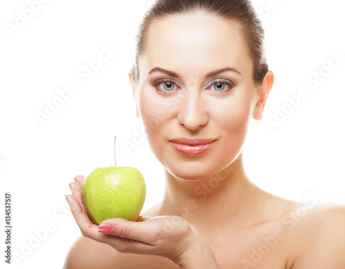 Young happy smiling woman with green apple