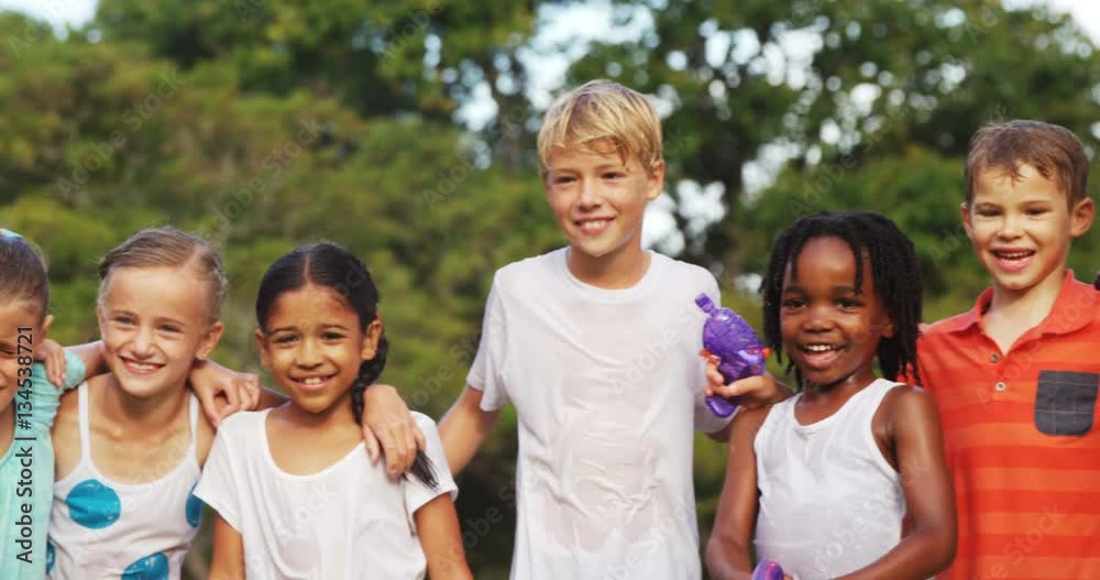 Group of kids standing together with arms around in garden on a sunny day 4k Group of kids standing together with arms around in garden on a sunny day 4k