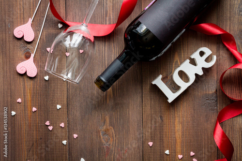 concept Valentine Day with wine at wooden background top view