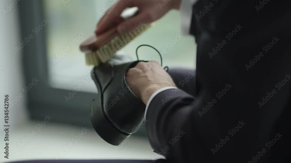 SLO MO CLOSE UP Man polishing black leather shoe