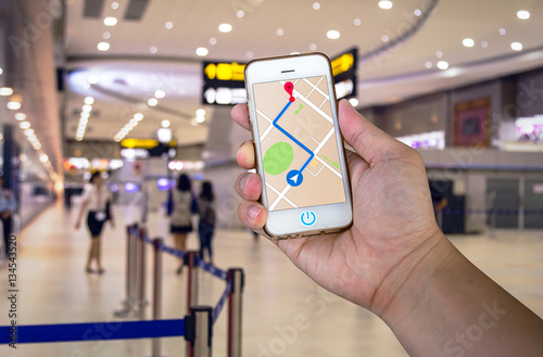 Man is holding mobile phone with map gps navigation.