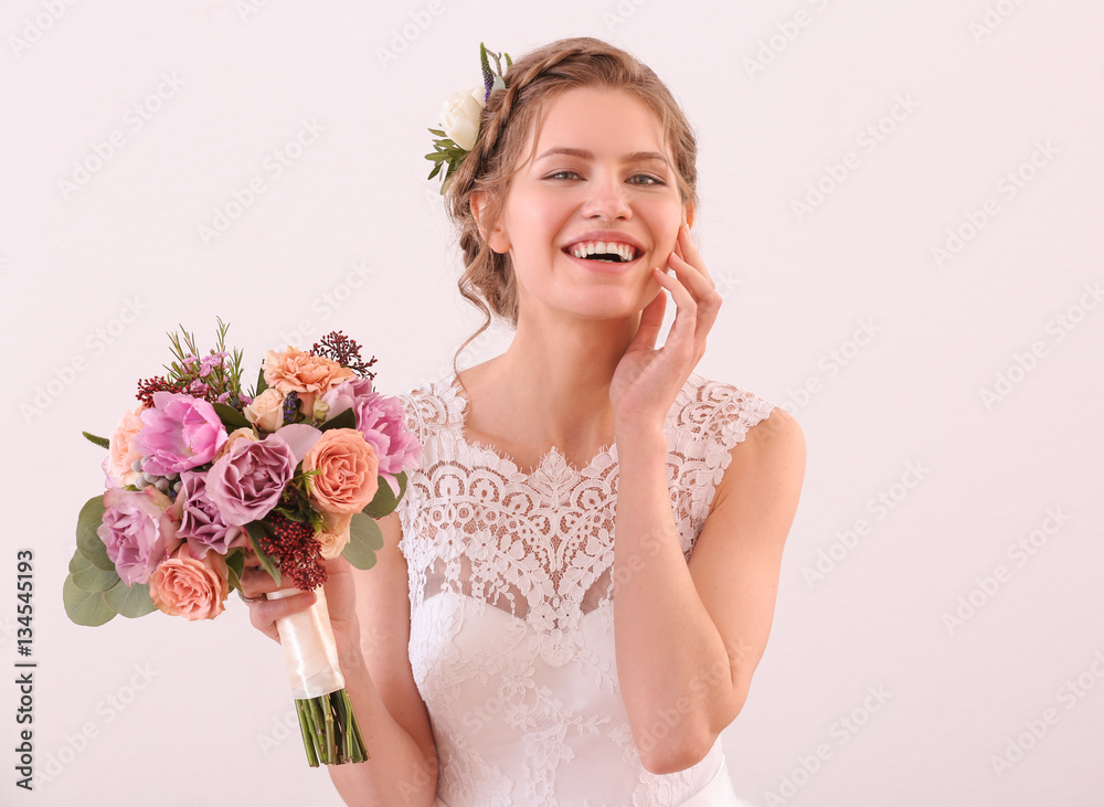 Young beautiful bride holding wedding bouquet on white background Young beautiful bride holding wedding bouquet on white background