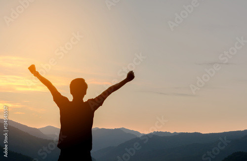 Man Silhouette Raised Up hands with Sunrise