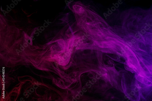 Abstract smoke Weipa. Personal vaporizers fragrant steam. The concept of alternative non-nicotine smoking. Lilac smoke on a black background. E-cigarette. Evaporator. Taking Close-up. Vaping.