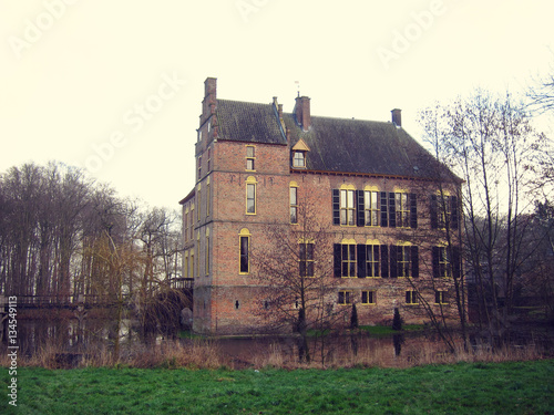 Ancient medieval stone fortress surrounded by water channel, cas photo