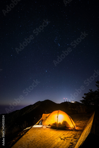 The camping with stars on the top of the mountain.