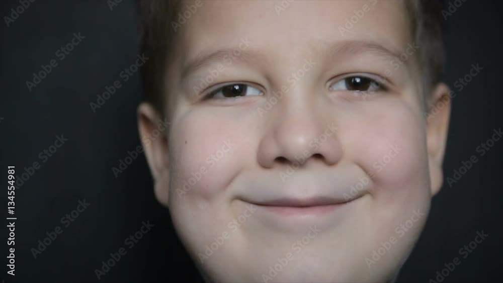 Portrait of a boy close-up on a black background. Full hd video Portrait of a boy close-up on a black background. Full hd video