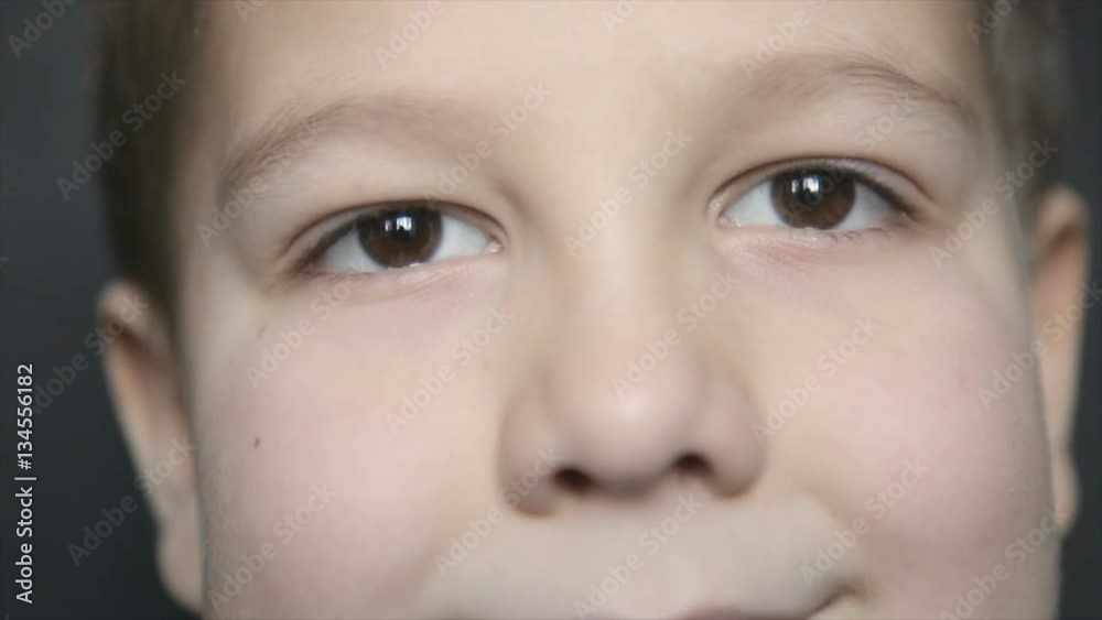 Portrait of a boy close-up on a black background. Full hd video Portrait of a boy close-up on a black background. Full hd video