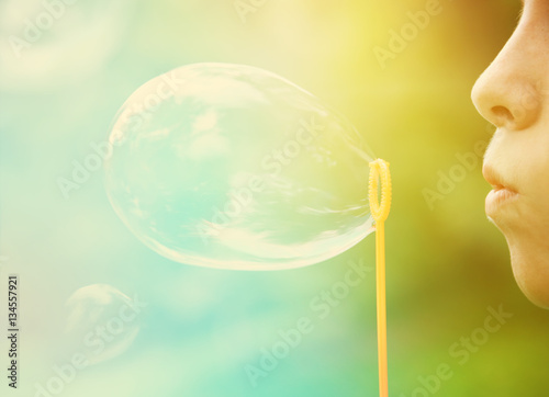 Child blowing bubbles. Instagram effect