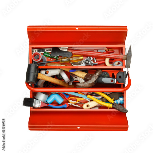 Red metal tool box with tools on white background.