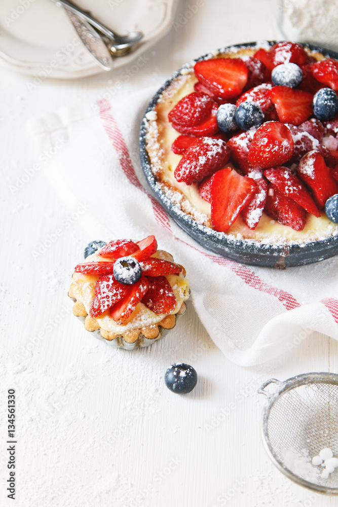 Delicious berry tart (tartlet) with cream on white background. Copy space Delicious berry tart (tartlet) with cream on white background. Copy space