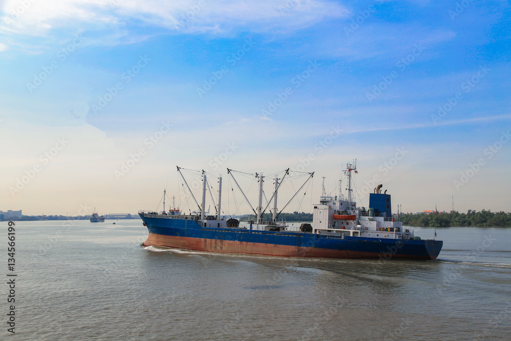 Logistic concept,Cargo ship was sailing out of the port within the river. To the sea And next to the port of destination.