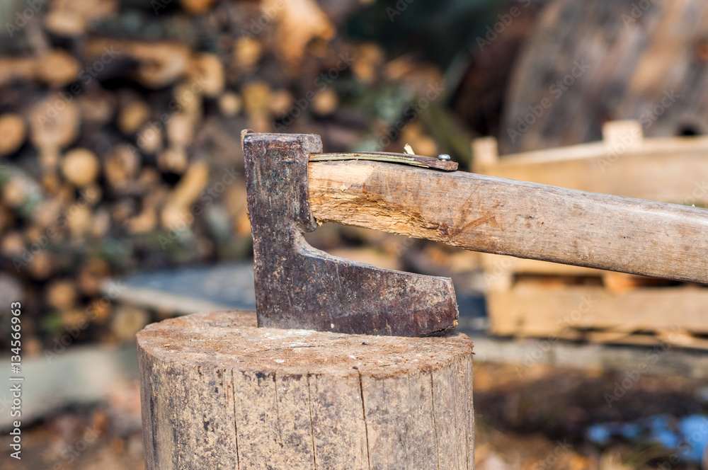 chopping wood with ax. Ax stuck in a log of wood. Old, worn, 