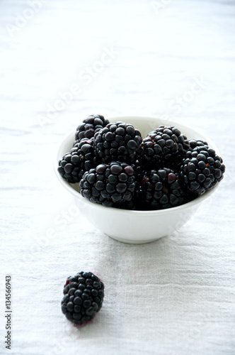 Fresh ripe balckberry in a bowl on a table photo