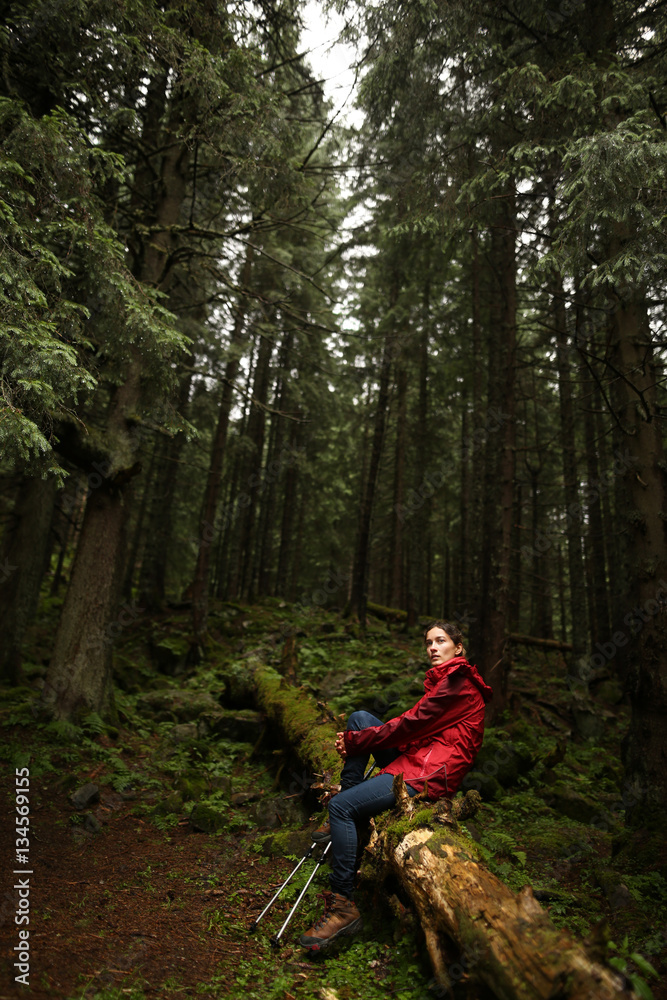 Young woman tourist walking along the trail in the rain forest