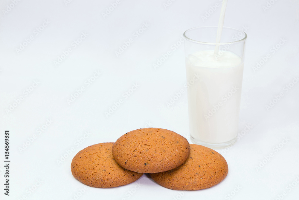 Oat cookies and milk.
Closeup of delicious oat cookies and a glass of milk on white background. Oat cookies and milk.
Closeup of delicious oat cookies and a glass of milk on white background.