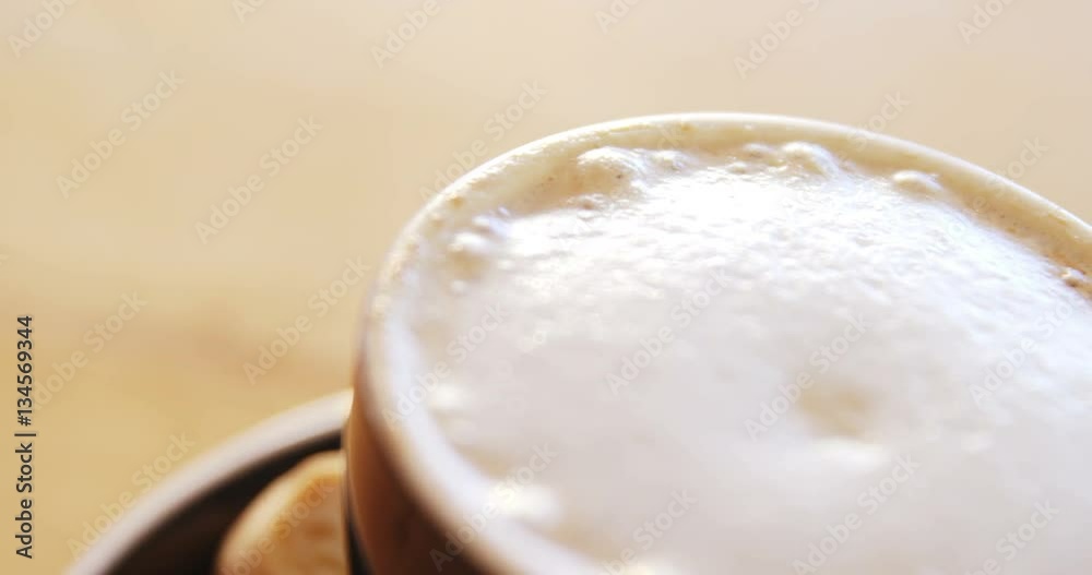 Close up of creamy coffee on wooden table in cafe 4k Close up of creamy coffee on wooden table in cafe 4k