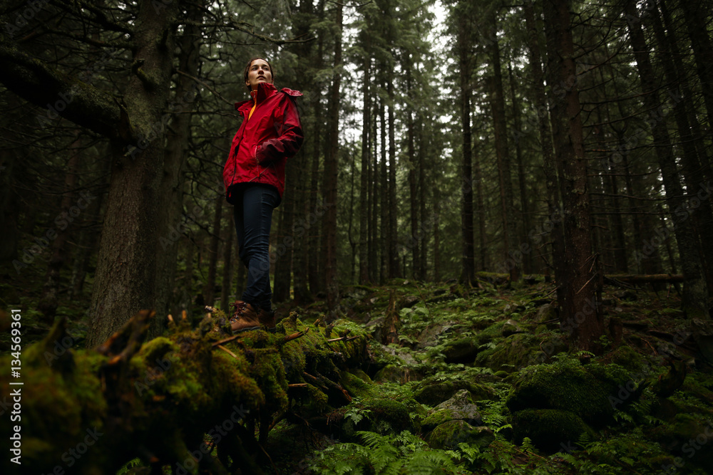 Young woman tourist walking along the trail in the rain forest Young woman tourist walking along the trail in the rain forest