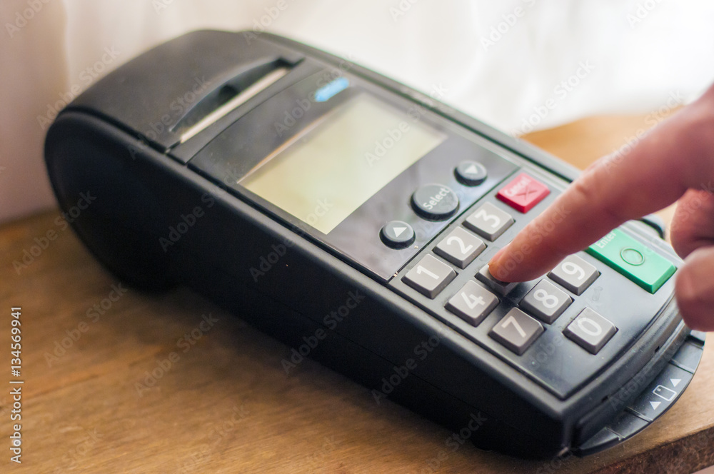 Payment card in a bank terminal. The concept of of electronic payment Payment card in a bank terminal. The concept of of electronic payment