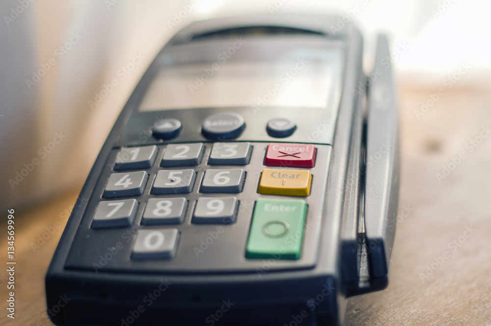 Payment card in a bank terminal. The concept of of electronic payment Payment card in a bank terminal. The concept of of electronic payment