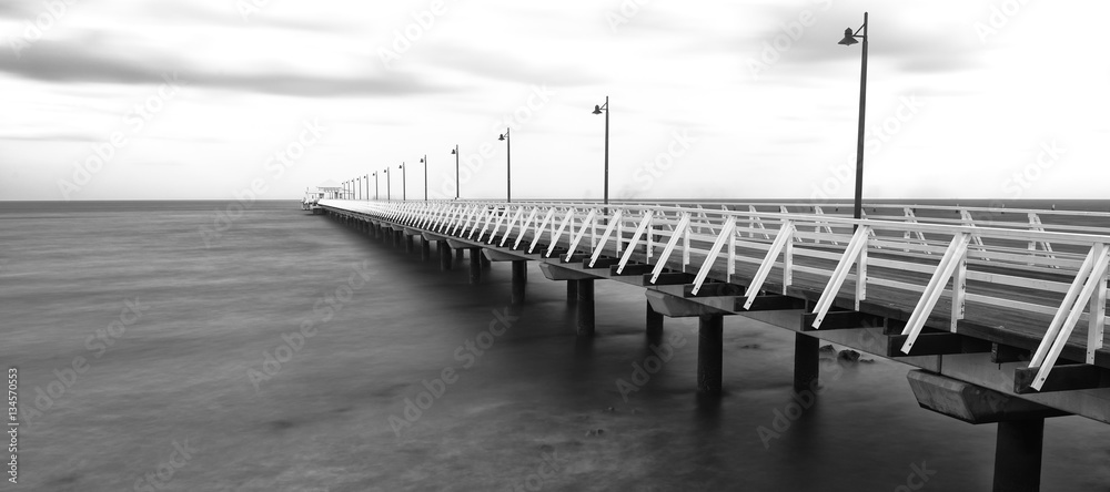 Fototapeta premium Black and white image of Shorncliffe Pier in Queensland, Australia.