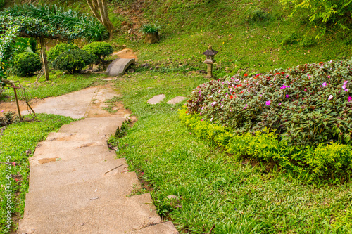Obraz na płótnie Asian tranquil garden with stone path, pond with beautiful landscape design w salonie