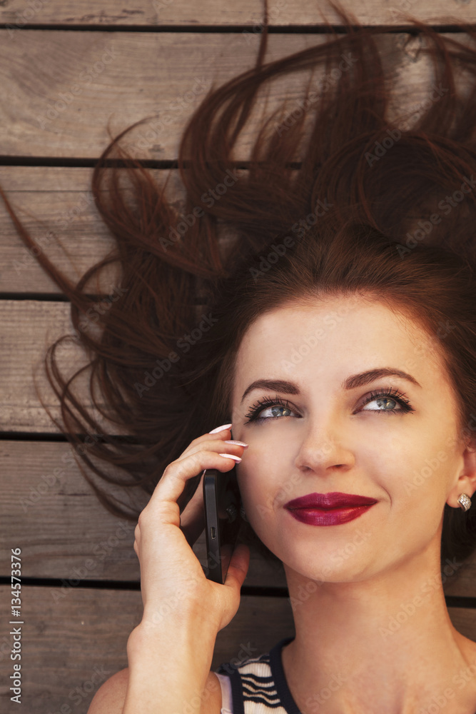 Beautiful young happy woman smiling during a phone call Beautiful young happy woman smiling during a phone call