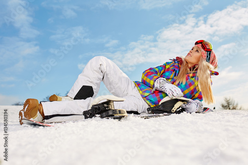 girl snowboarding in the mountains on the snowboard