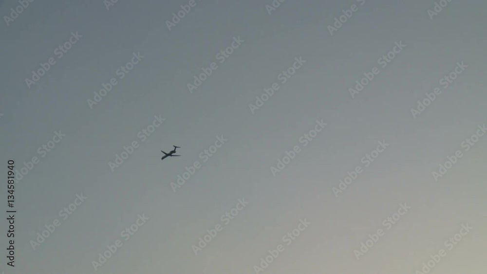Passenger Jet Plane Flies Through Clear Skies at Dusk Passenger Jet Plane Flies Through Clear Skies at Dusk