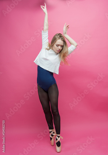 Girl in black tights dancing on a pink background Stock Photo by