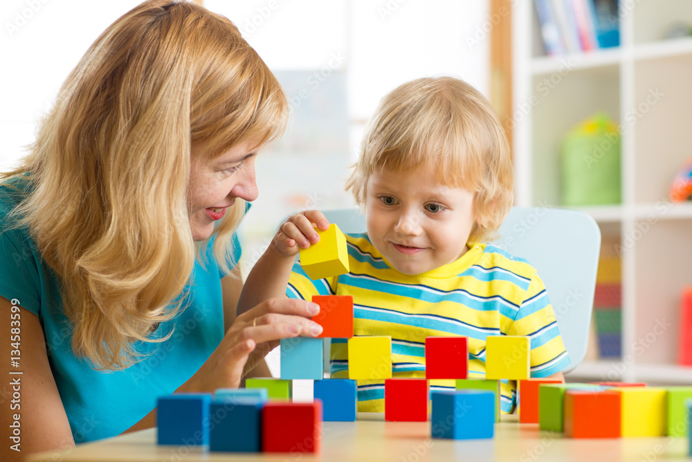 cute mother and kid boy play together with educational toys cute mother and kid boy play together with educational toys