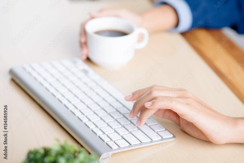 Hands on keyboard and coffee cup Hands on keyboard and coffee cup
