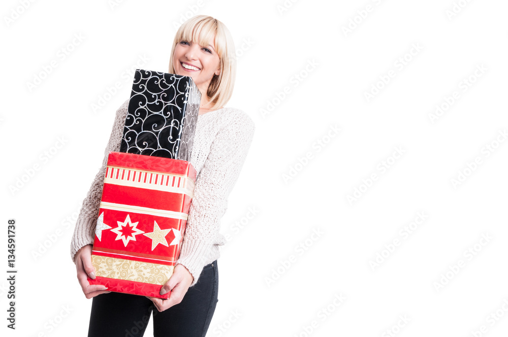 Smiling lady wearing warm sweater holding presents Smiling lady wearing warm sweater holding presents