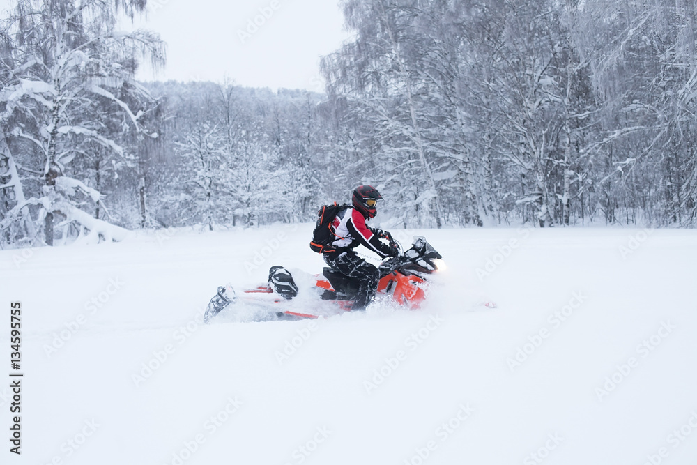 Winter Finnish snowy lanscape with road and snowmobile