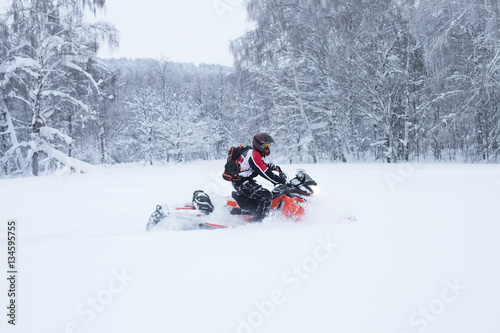 Winter Finnish snowy lanscape with road and snowmobile