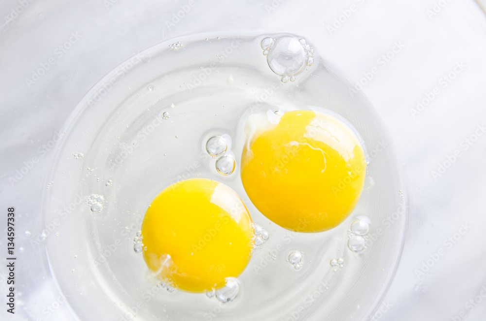 Beautiful picture of eggs in a white bowl with beaters near yolk Beautiful picture of eggs in a white bowl with beaters near yolk