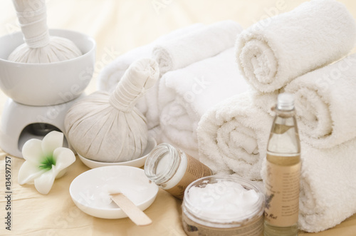 Spa treatment with towels and herbal creams and scrubs on beautiful soft background