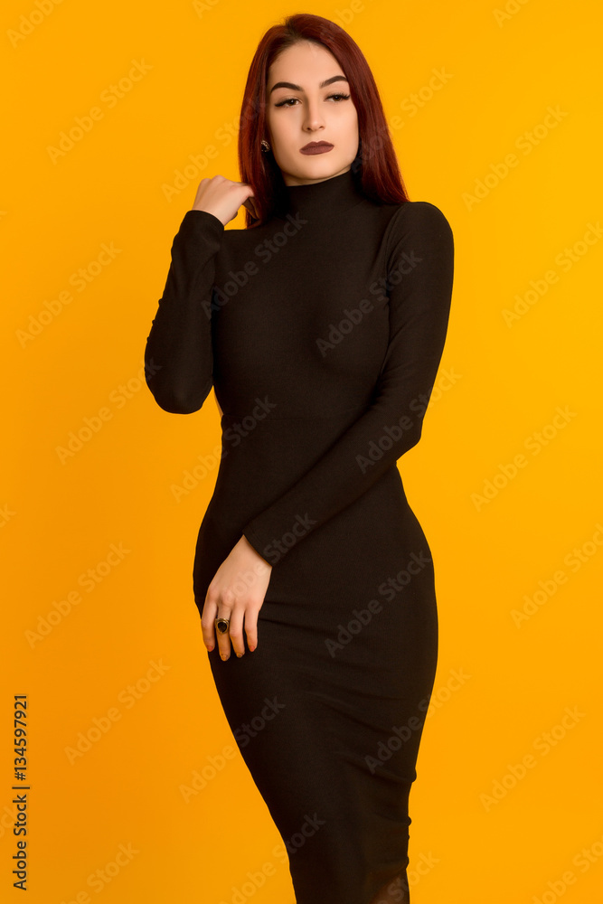 Fototapeta premium beautiful girl in a long black dress posing