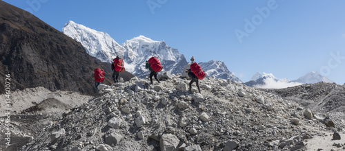 Nepal, Himalaya, Khumbu, Everest region, Porters on Ngozumpa glacier photo