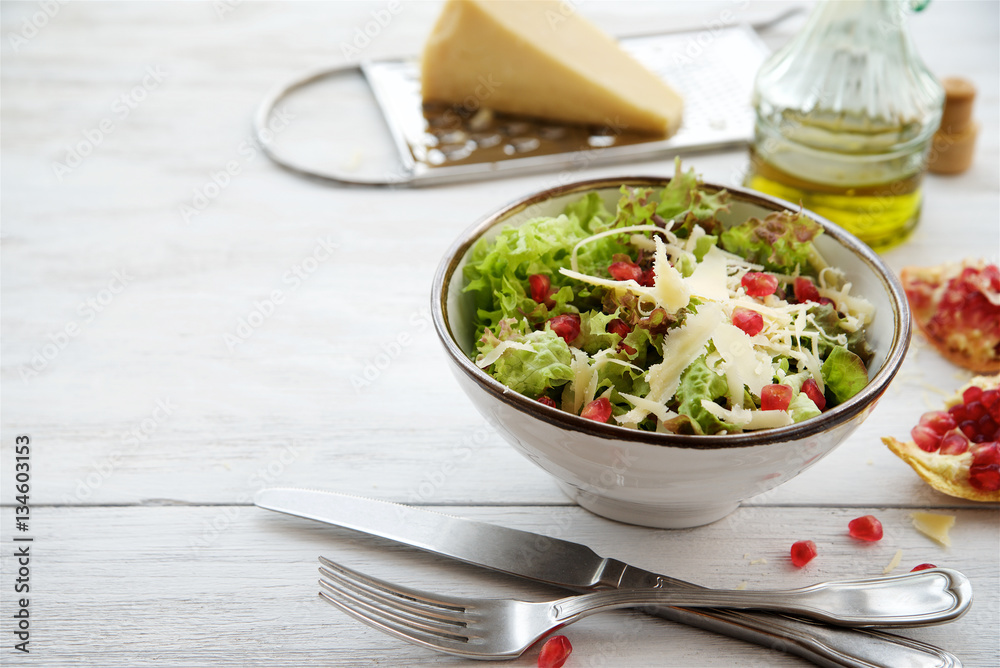 Salad lettuce with parmesan cheese and pomegranate seeds
Salad lettuce with parmesan cheese and pomegranate seeds