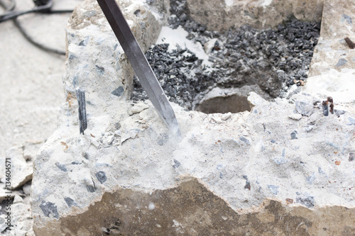 Construction worker removes excess concrete