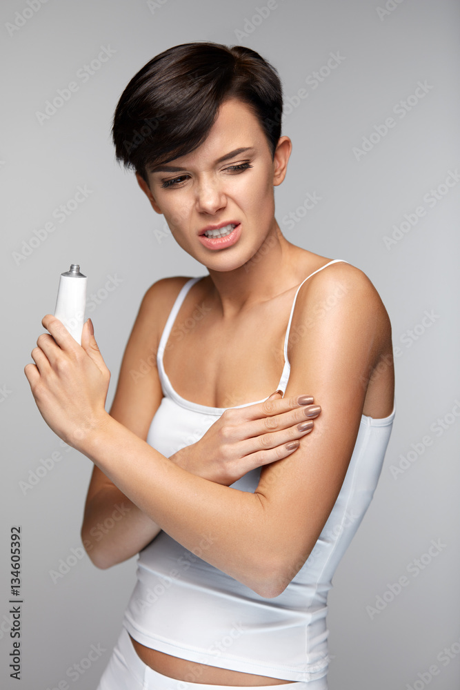 Body Pain. Beautiful Woman Feeling Pain In Arms, Applying Cream Body Pain. Beautiful Woman Feeling Pain In Arms, Applying Cream