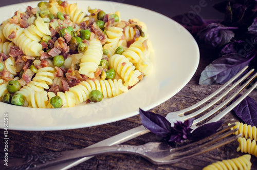 Pasta with prosciutto on wooden background