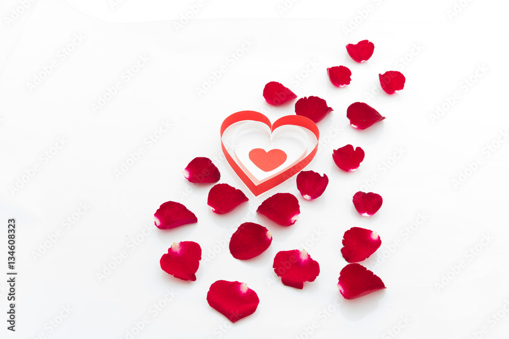 Rose petals and heart paper isolated on white